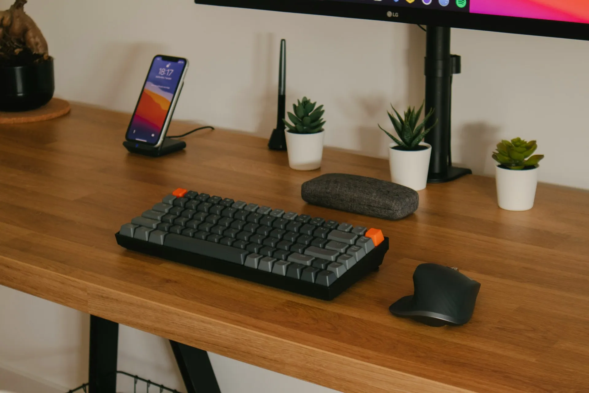 Person seated at a desk using a keyboard and mouse in a home office