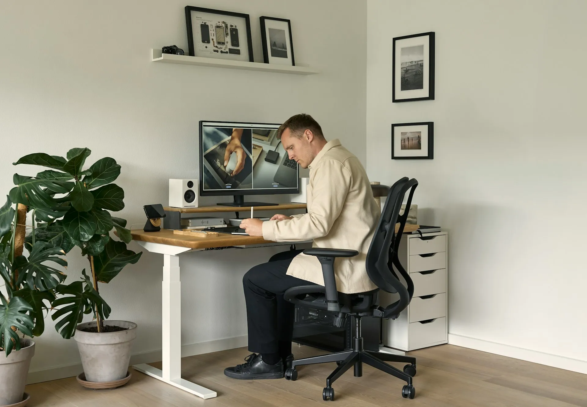 Person seated at a desk using an adjustable office chair in a home office